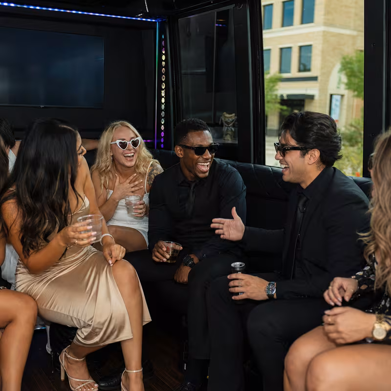 Party bus interior with wraparound leather seating and LED lighting in Carrollton