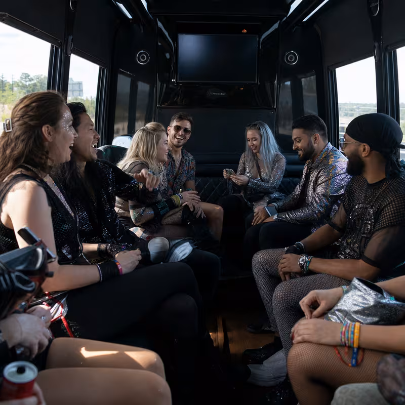 Group boarding a white charter bus for Concert Transportation transportation in Carrollton