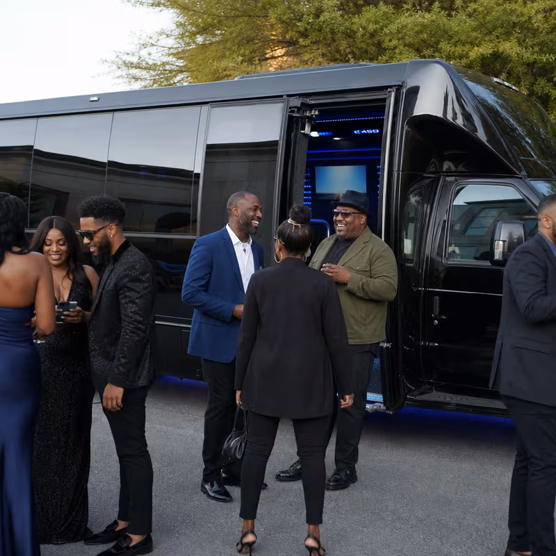 Passengers loading luggage while boarding an Carrollton group shuttle